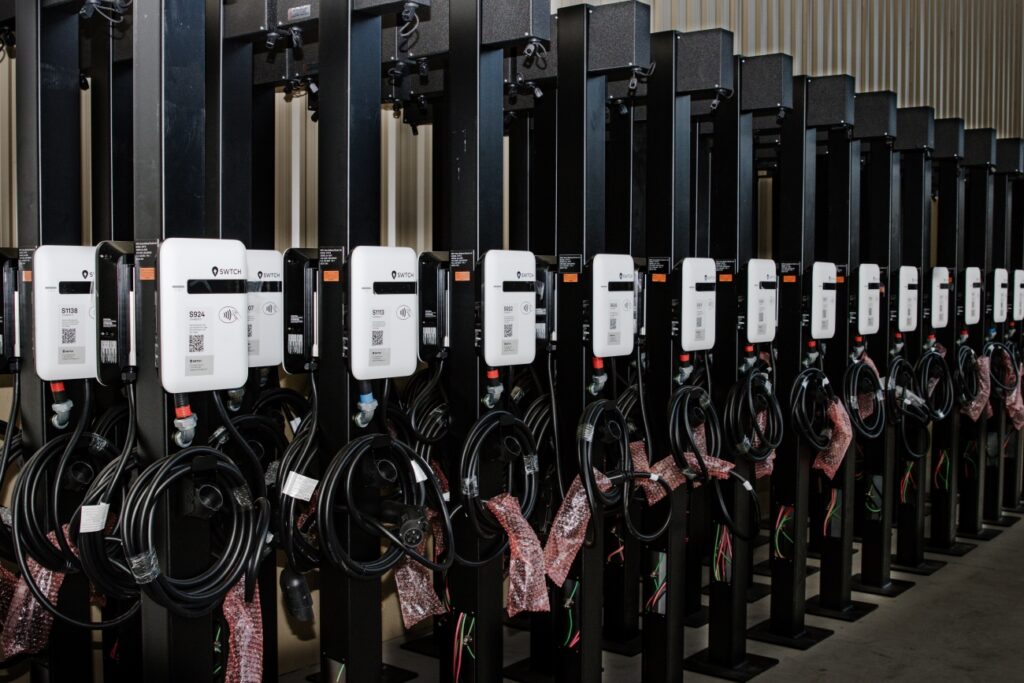 Dozens of SWTCH EV chargers lined up, ready to be installed